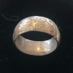 Silver wedding band with delicate inscribed design.  Size 6.+